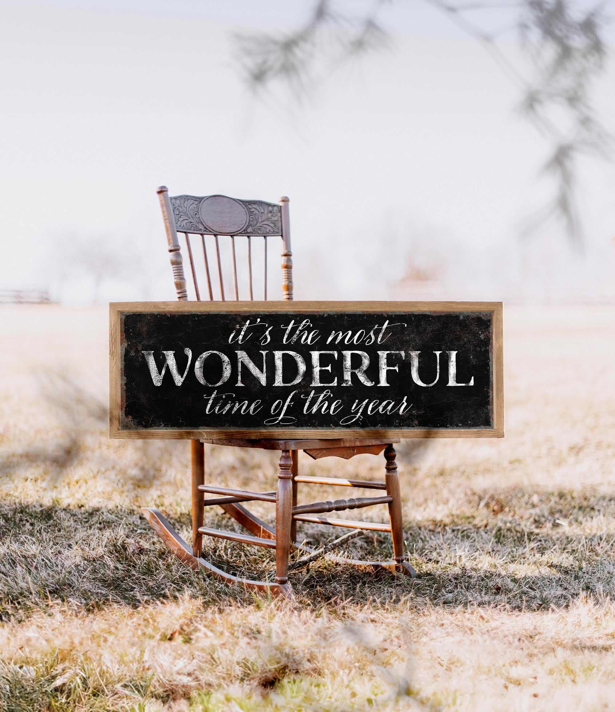 a wooden rocking chair with a sign that says it's the most wonderful time