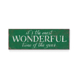 a green sign that says it's the most wonderful time of the year