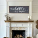 a fireplace with a sign above it that says it's the most wonderful time