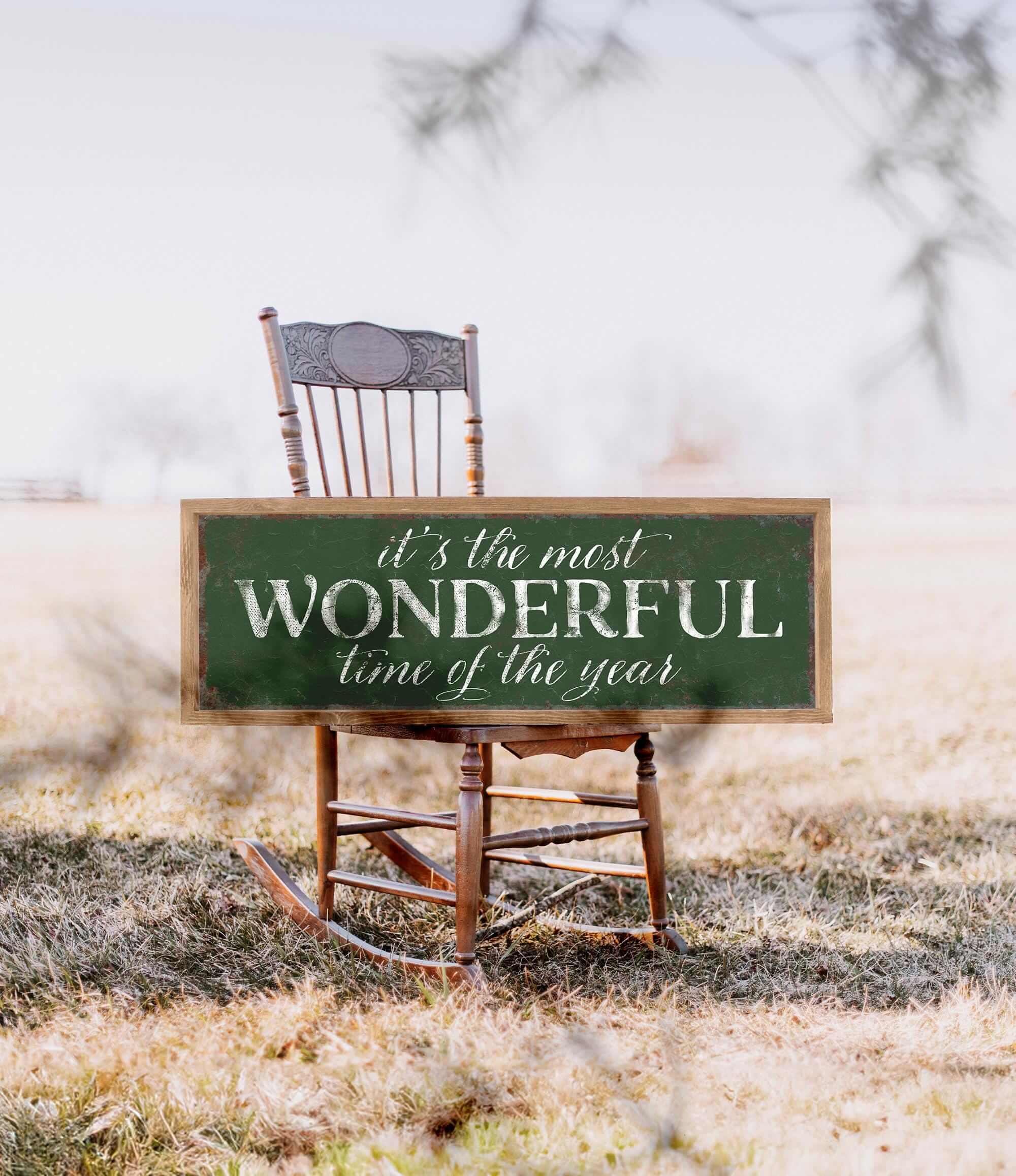 a wooden rocking chair with a sign that says it's the most wonderful time