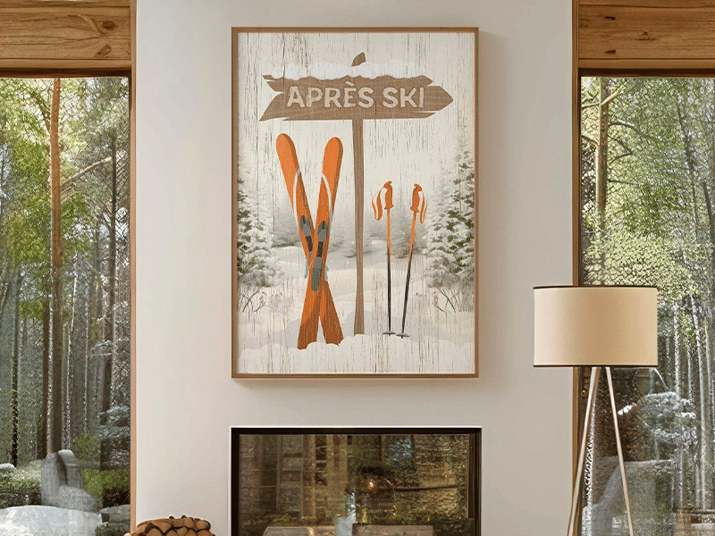 Cozy living room with large windows, a fireplace, and a ski-themed "Après Ski" poster above the mantel.
