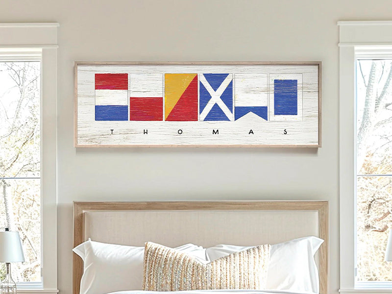 A framed sign with nautical flags above the word "JOHNSON" on a white, weathered background.