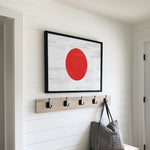 a picture of a red circle hanging on a wall