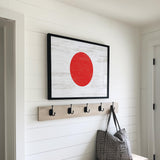 a picture of a red circle hanging on a wall