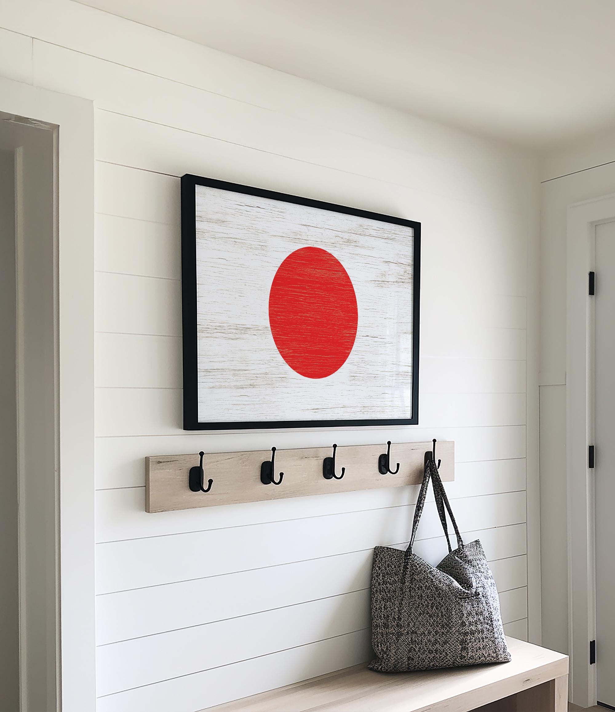 a picture of a red circle hanging on a wall