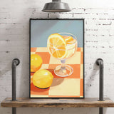 A framed painting depicting a glass of lemonade with lemon slices on a checkered tablecloth, set against a brick wall.