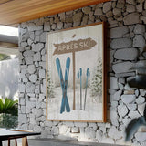 The Cerulean Après Ski Signpost Wall Art features vintage charm with skis and poles, perfect for adding après ski style to a cozy, modern room.