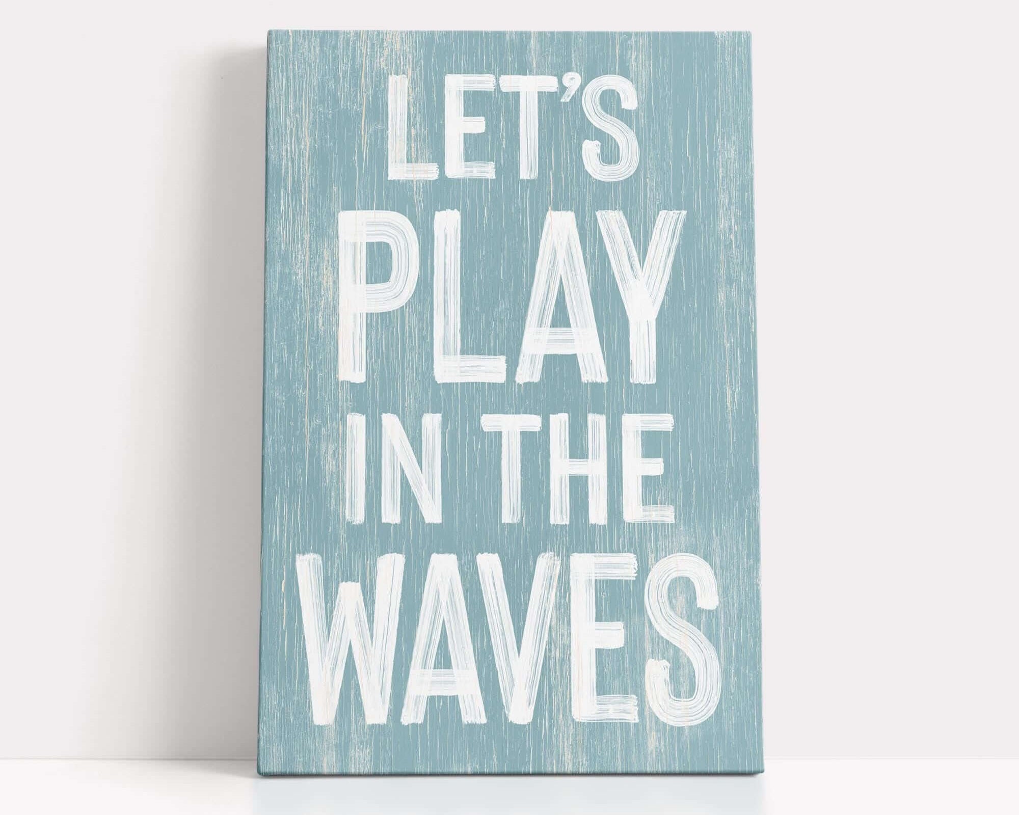 a wooden sign that says let's play in the waves