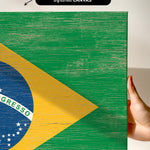 a person holding a piece of wood with a flag painted on it