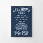 a sign that says lake house rules hanging on a wall