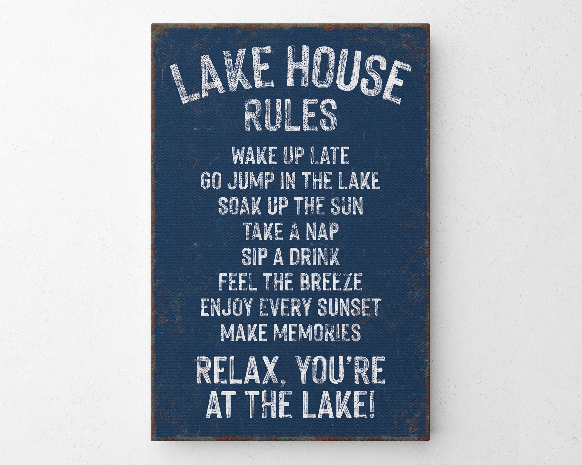 a sign that says lake house rules hanging on a wall