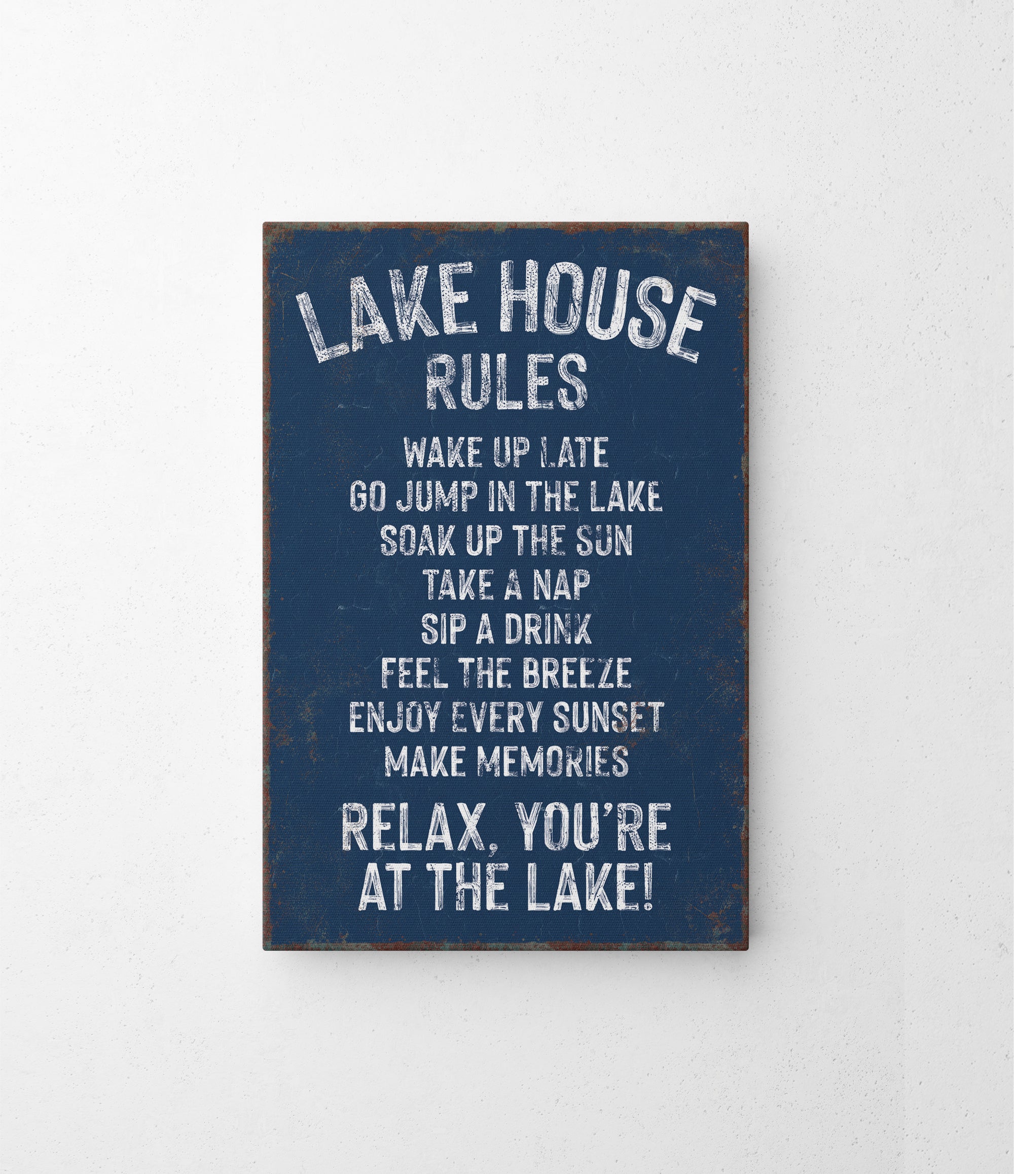 a sign that says lake house rules hanging on a wall