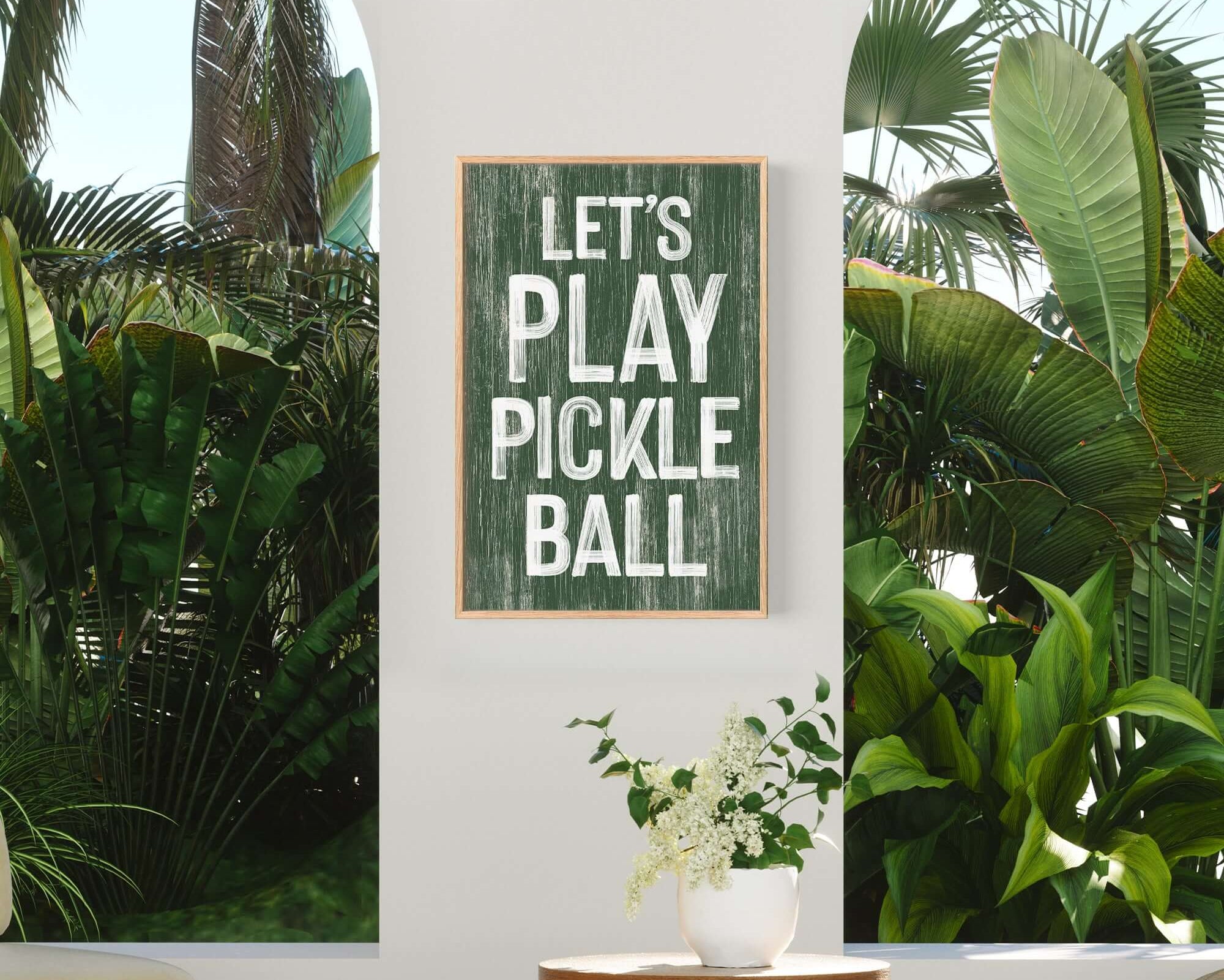 a picture of a play pickle ball sign on a wall