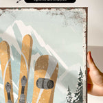 a person holding up a poster with skis on it