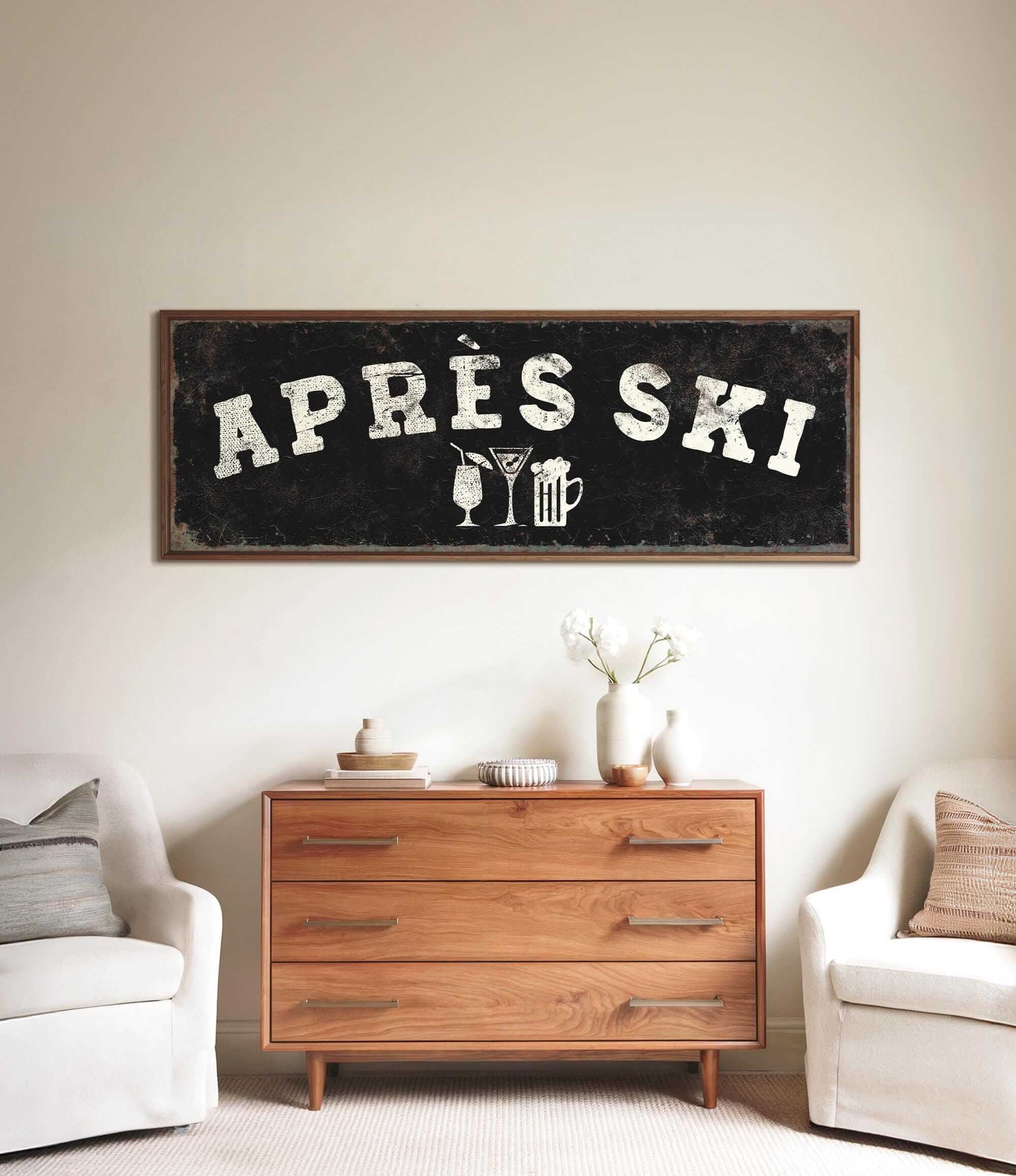 a wooden dresser with a sign above it that says "APRÈS SKI", and there are two white chairs and a vase with flowers on the dresser.