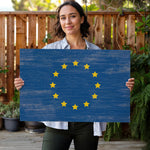 a woman holding a sign with the flag of the european union