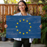 a woman holding a sign with the flag of the european union