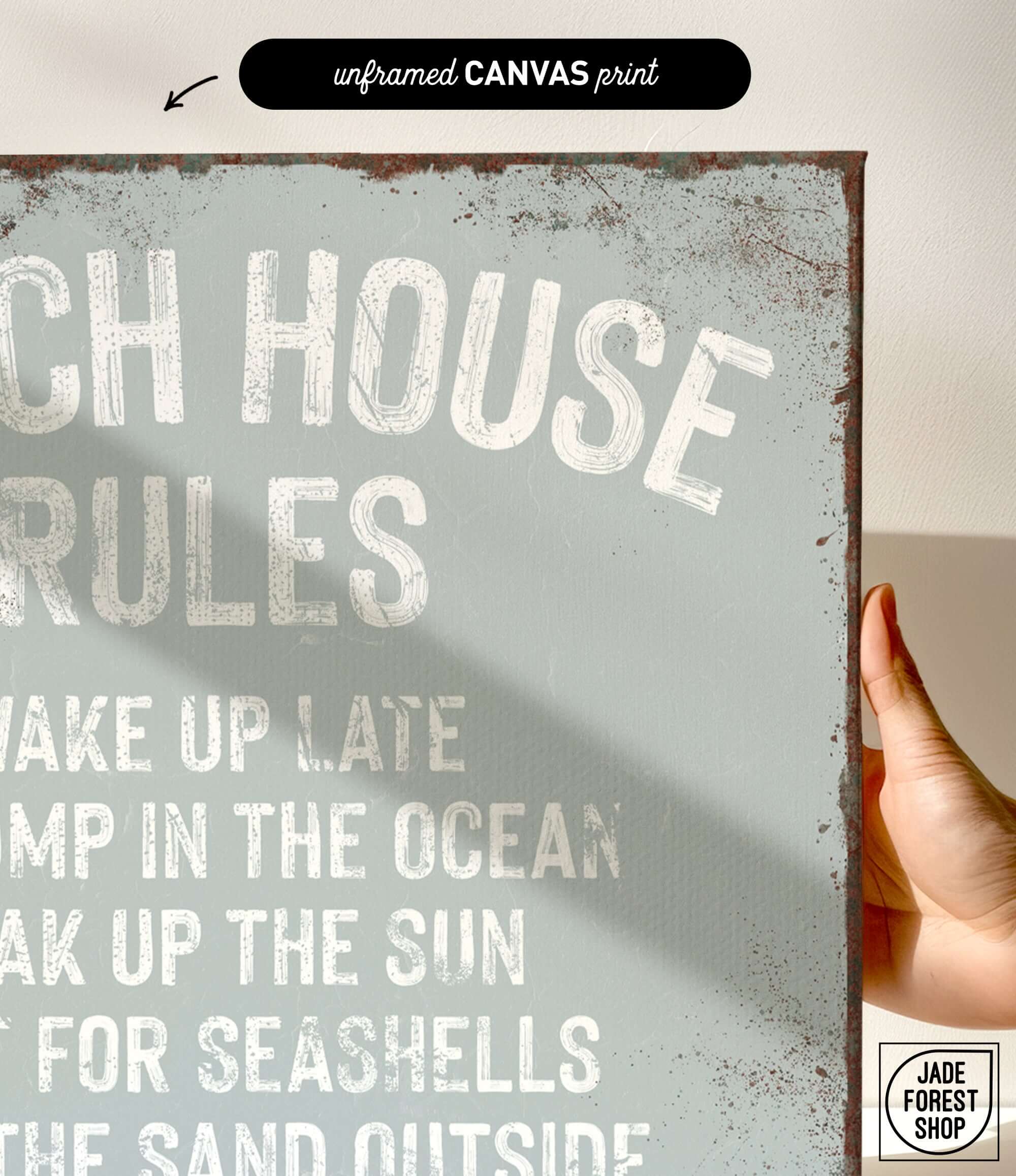 a hand holding a sign that says beach house rules