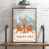 A framed poster with an illustration of two wooden chairs and skis, set against a snowy mountain backdrop, with the text "Apres-skii" below the image.