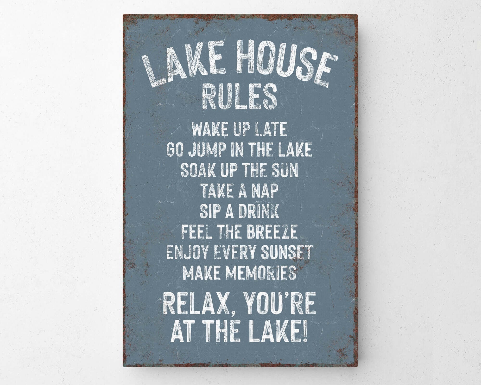 The image is a sign that provides a list of rules for visitors at a lake house.
