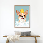 A framed illustration of a dog with a yellow rubber duck on its head, surrounded by bubbles, is hanging on a white wall above a wooden bench.