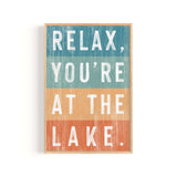 a wooden sign that says relax you're at the lake