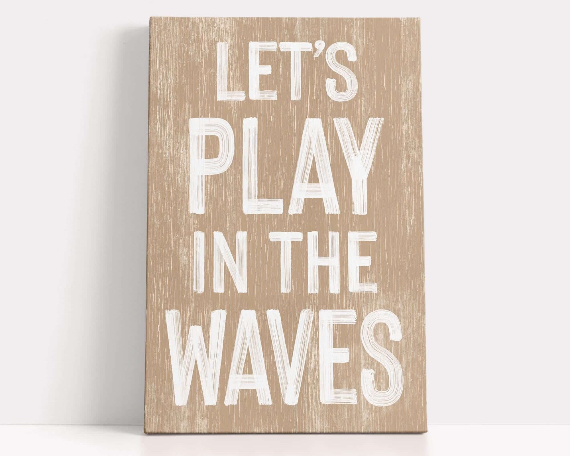 a wooden sign that says let's play in the waves