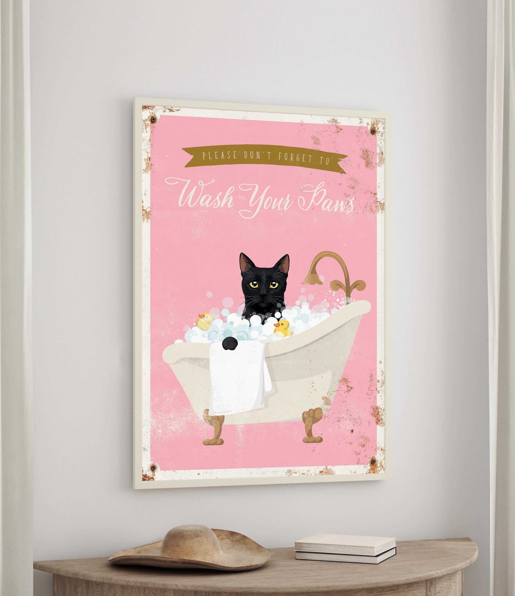 A framed poster with a black cat sitting in a bathtub filled with bubbles, accompanied by the text "Please don't forget to wash your pans".
