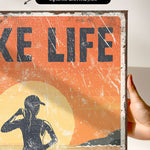 a person holding up a sign that says take life