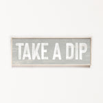 a wooden sign that says take a dip