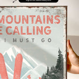 a hand holding a sign that says mountains are calling