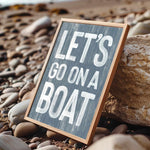 a sign that says let&#39;s go on a boat on the beach