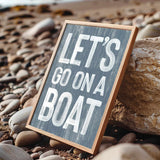 a sign that says let&#39;s go on a boat on the beach