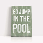 a green sign that says go jump in the pool