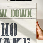 a hand holding a sign that says draw down no wake