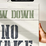a hand holding a sign that says draw down no wake