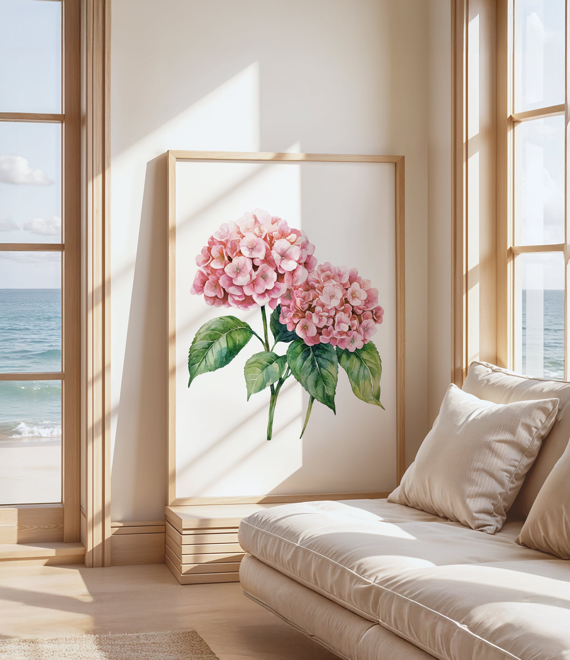 a large framed painting of pink hydrangeas on a wall, with a view of the ocean through a window in the background.