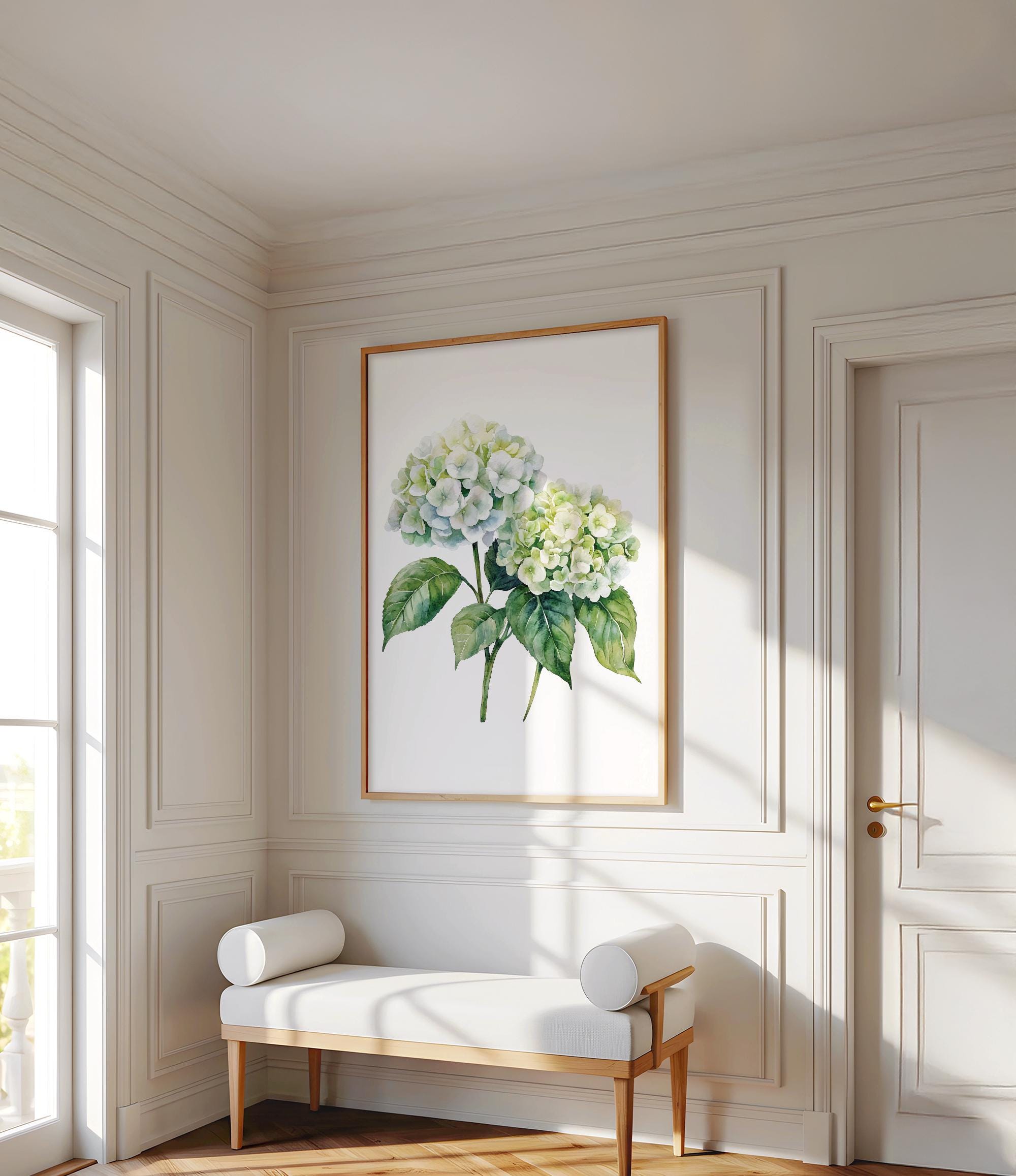 a white room with a large painting of a green hydrangea flower hanging on the wall. In front of the painting, there is a white bench with two white cushions. The room has white walls and a wooden floor, creating a clean and elegant atmosphere.