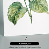 The image is an aluminum print featuring a watercolor painting of a green leaf on a stem.