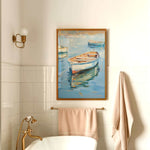 a bathroom with a white bathtub, a towel rack, and a framed painting of a boat on the wall.
