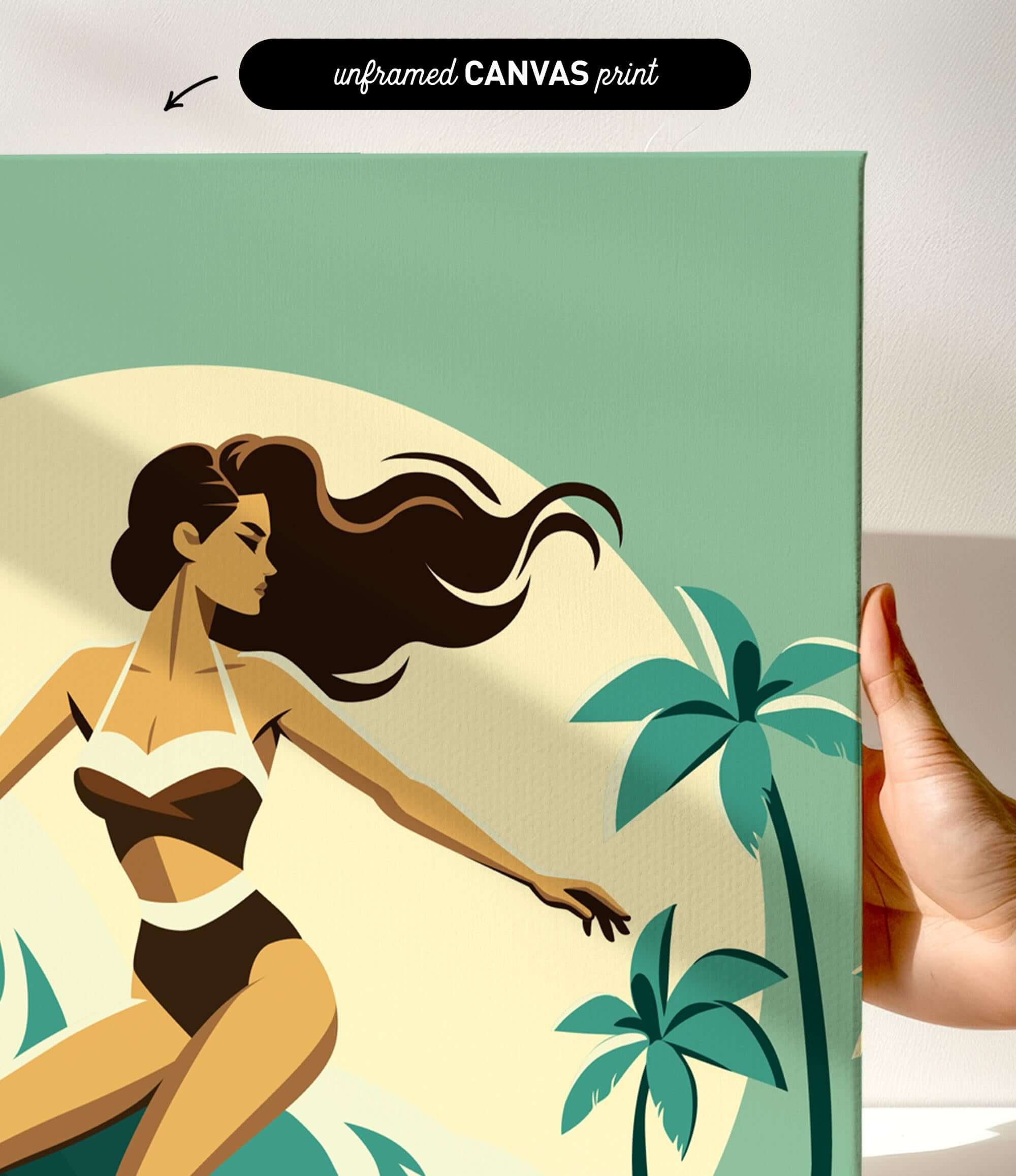 a hand holding a framed canvas print of a stylized illustration of a woman in a swimsuit, with palm trees and a sunset in the background.
