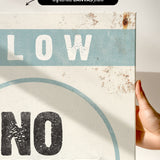 a hand holding a sign that says slow no wave