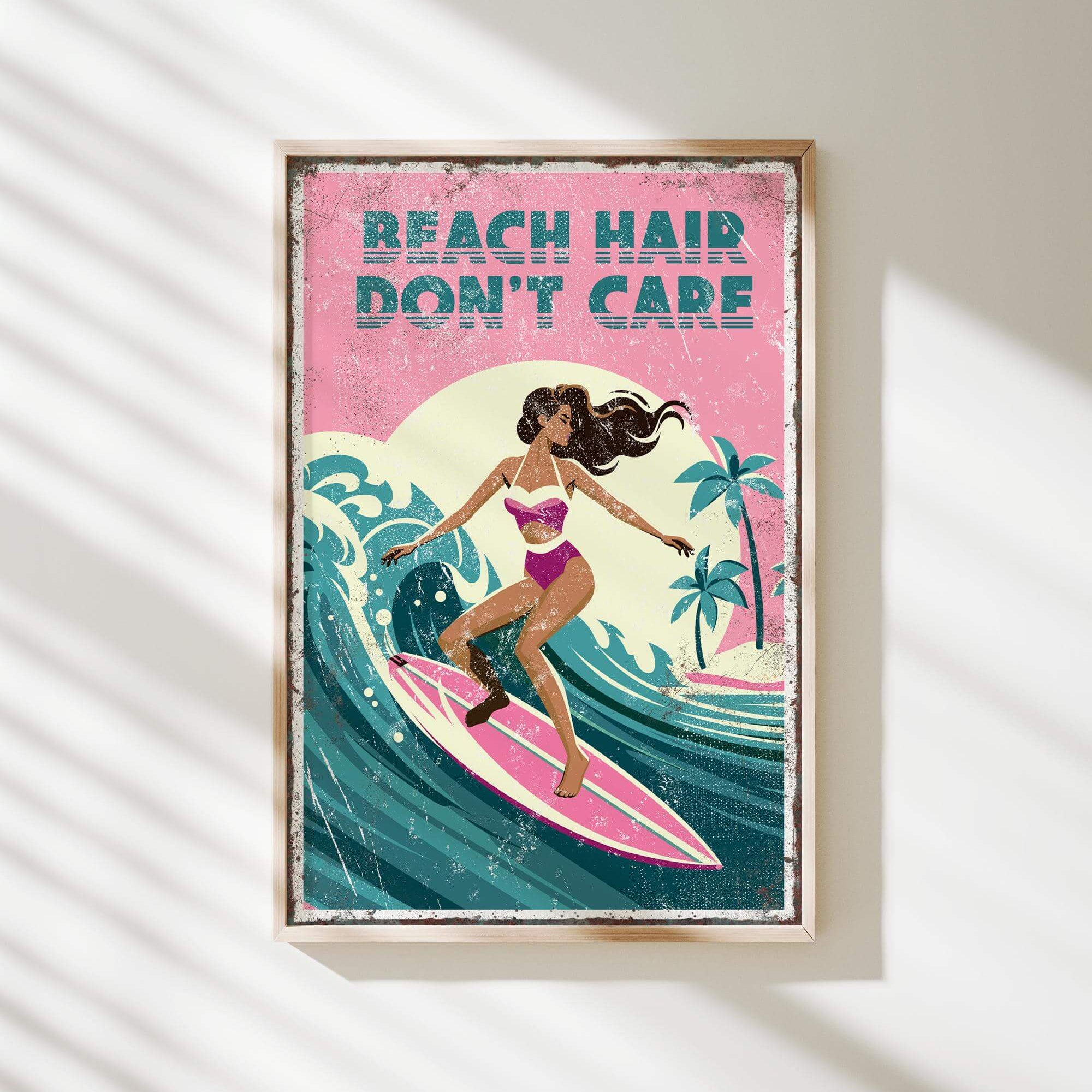 A framed poster with a woman surfing on a pink surfboard, with the text "REACH HAIR DON'T CARE" written above her.