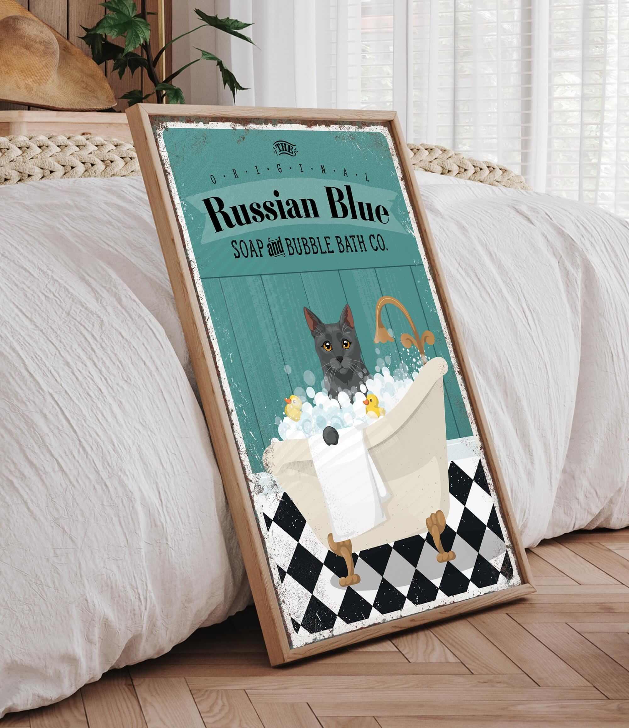 A framed poster featuring a cat sitting in a bathtub filled with bubbles, with the text "Russian Blue SOAP & BUBBLE BATH CO."