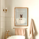 a bathroom with a framed poster of a dog sitting in a bathtub, accompanied by the text "WASH YOUR PAWS".
