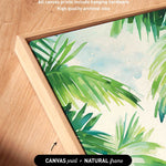 a close-up view of a vibrant, tropical-themed canvas print with lush palm leaves and foliage. The artwork is framed in a natural wooden frame, and the text indicates that the artwork wraps around the sides of the canvas, and all canvas prints include hanging hardware and high-quality archival inks.