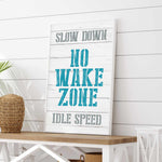 a sign that says slow down, no wake zone, idle speed