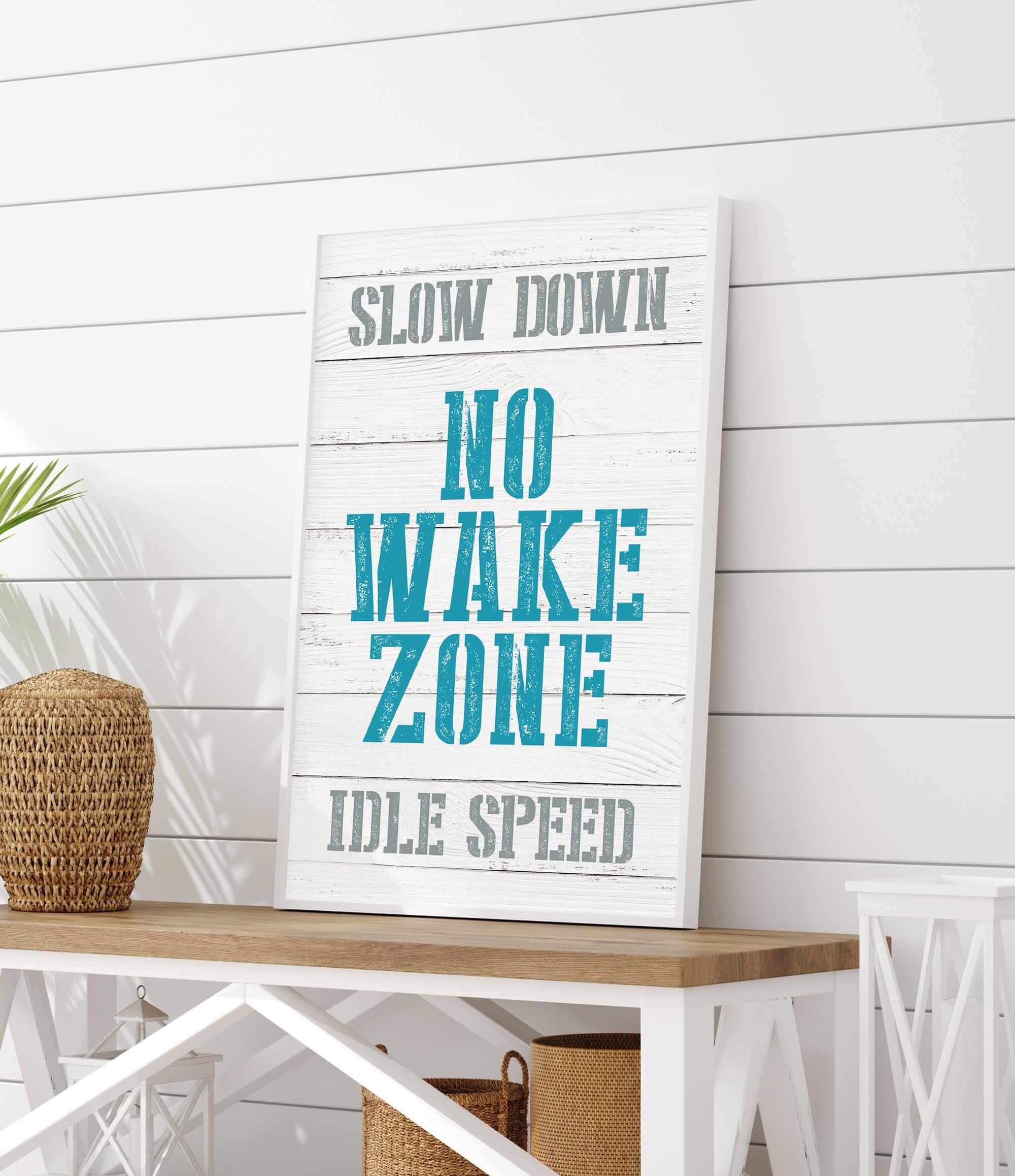 a sign that says slow down, no wake zone, idle speed