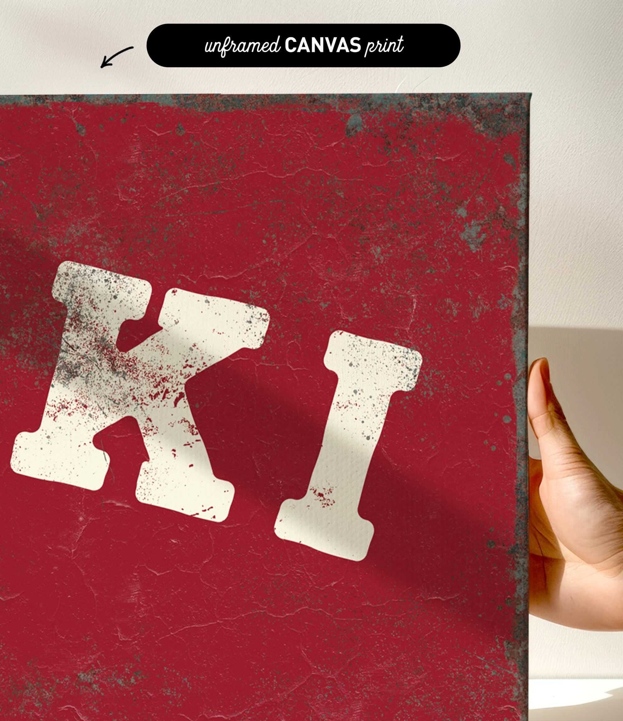 a close-up of a red, textured surface with a large white letter "K" prominently displayed.