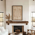 a cozy living room with a rustic wooden mantel, a comfortable couch, and a fireplace. Above the mantel, there is a wooden sign that reads "BEACH HOUSE RULES" and provides a list of beach-related activities, such as "Make up late", "Go jump in the ocean", " Hunt for seashells", " Hunt for shavings", " Hang up your towel", " Enjoy every sunset", and "Relax, you're at the beach!"
